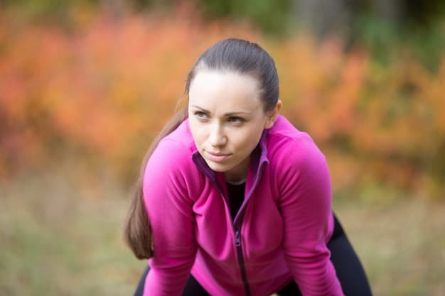 A female runner looking tired but determined against a blurred natural landscape backdrop, emphasizing the struggle with energy levels.