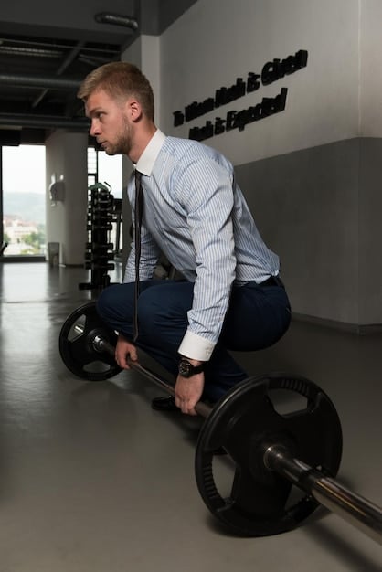 A person performing a barbell deadlift with proper form, showing strength and focused effort in a gym.