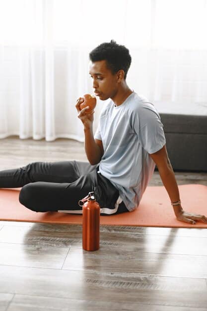 A serene image of an athlete stretching or meditating after a workout, emphasizing the importance of recovery. A water bottle and healthy snacks are visible nearby.
