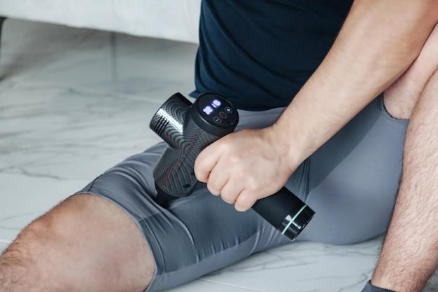 An athlete using a percussive massage gun on their leg muscles, highlighting the use of advanced recovery tools.