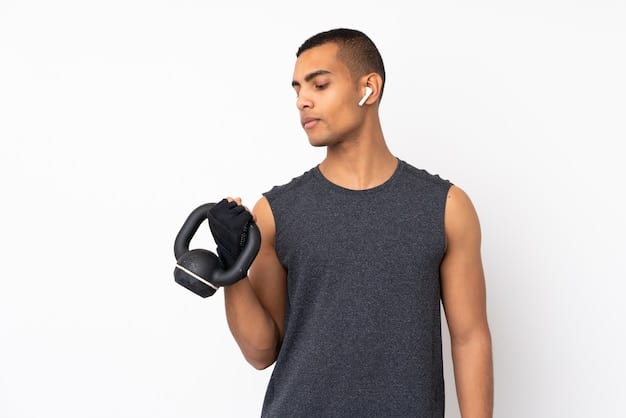 A person performing bicep curls with dumbbells in a gym, highlighting arm musculature and focused, isolated work.