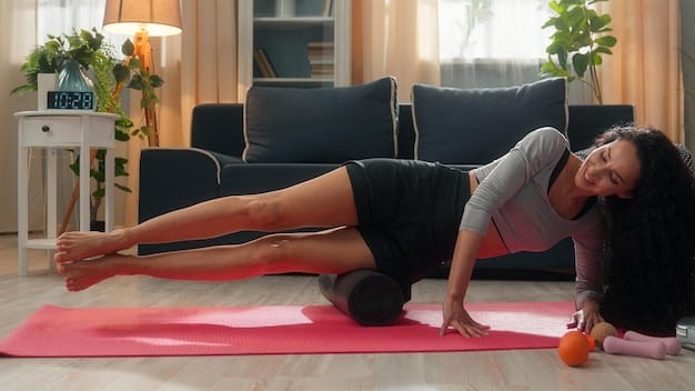 A person using a foam roller on their hamstring, demonstrating proper self-myofascial release technique in a gym.