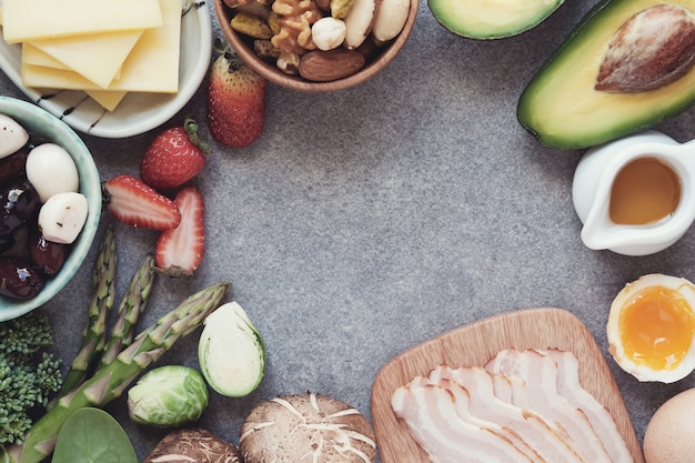 A detailed flat lay of various protein-rich foods and hydrating fruits on a wooden table, emphasizing a balanced diet for muscle recovery and growth.