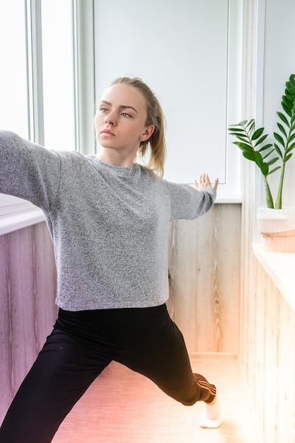 A person in comfortable athletic wear stretching their chest and shoulders, emphasizing flexibility and post-workout recovery in a calm, modern living room.