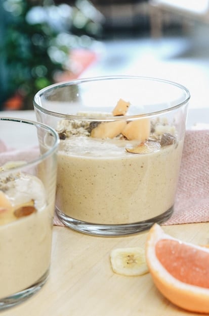 A close-up shot of a healthy pre-workout smoothie with ingredients like spinach, banana, protein powder, and almond milk, ready to be consumed.