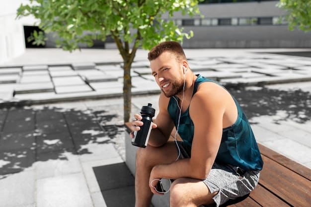 A person in gym attire, sitting on a bench, happily drinking a protein shake from a shaker bottle immediately after a workout. Sunlight streams through a large window in the background, illuminating the modern gym interior.
