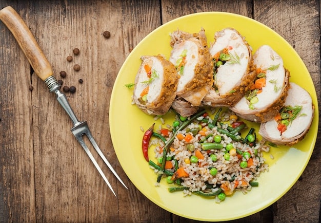 A perfectly portioned meal for a mesomorph, showing grilled chicken breast, a serving of brown rice, and a colorful mix of steamed vegetables. The plate is well-lit and appealing.