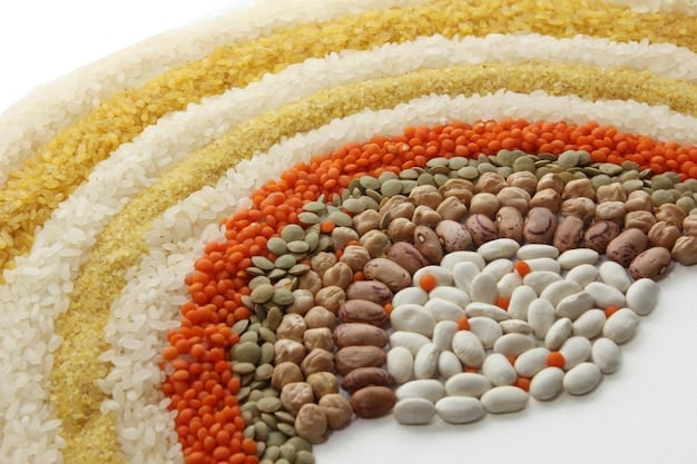 A vibrant, detailed image of an assortment of whole grains and legumes, such as quinoa, brown rice, lentils, and oats, highlighting healthy complex carbohydrate sources.