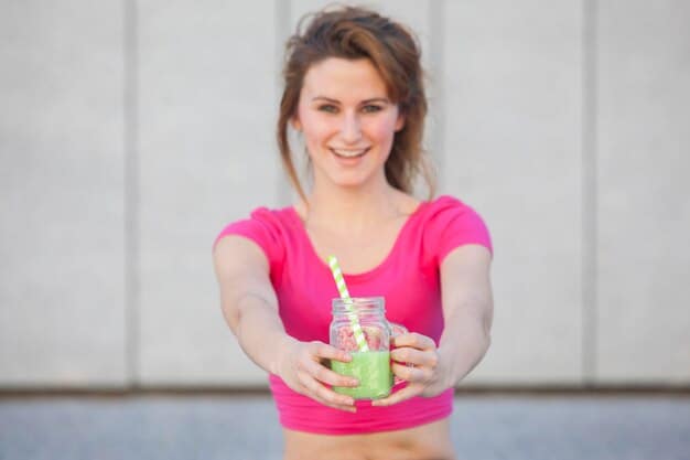 A person holding a protein shake and a piece of fruit after a workout, symbolizing post-exercise nutrition and recovery, well-composed and active.