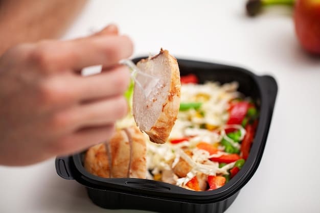 A close-up of a well-organized meal prep container filled with a no-cook bodybuilding meal, showcasing distinct sections for protein, carbs, and fats, emphasizing portion control and freshness.