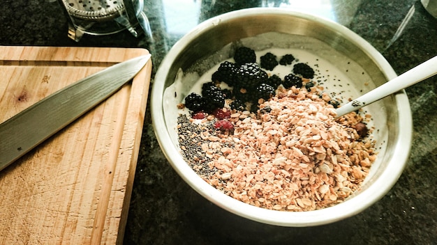 A close-up of a bowl filled with steel-cut oats, mixed berries, and a scoop of protein powder, representing a nutritious and energy-dense breakfast within a muscle-building meal plan.