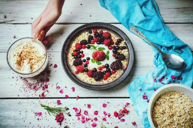 A colorful bowl of overnight oats with berries, chia seeds, and a scoop of protein powder, representing a healthy, high-protein breakfast.